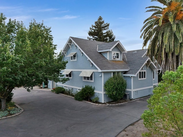 view of front of house with a garage and central AC