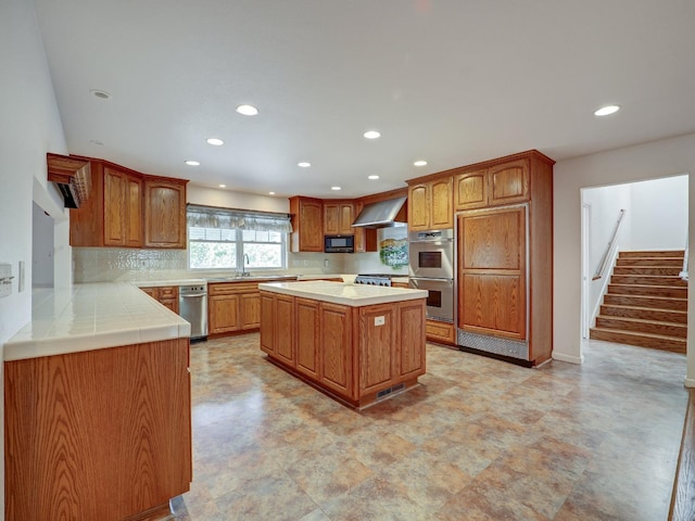 10951 River Rd, Courtland, CA 95615 - kitchen with a center island, stainless steel double oven, wall chimney range hood, tasteful backsplash, and kitchen peninsula