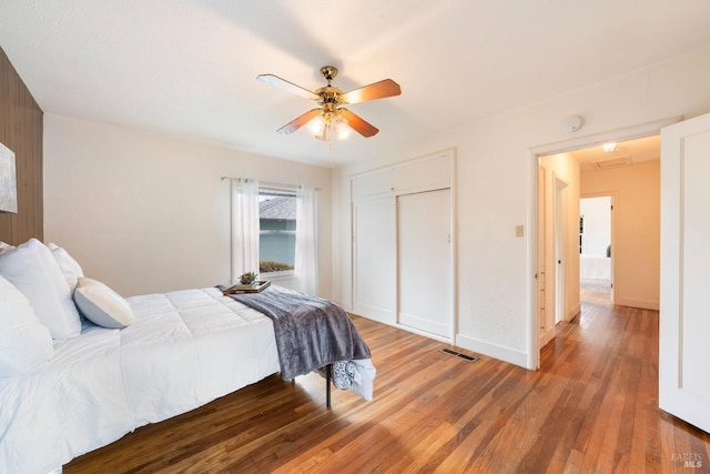 bedroom with ceiling fan and wood-type flooring