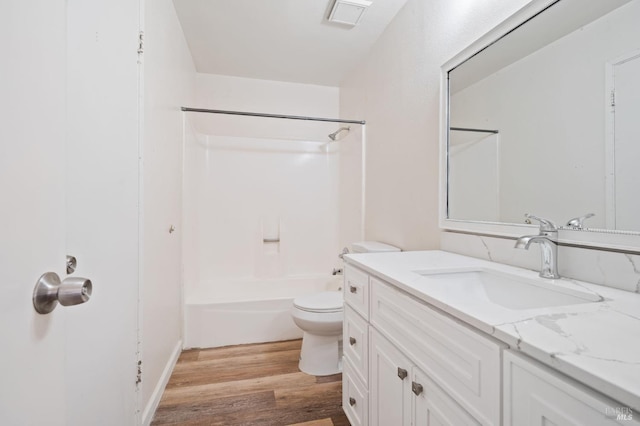 full bathroom featuring washtub / shower combination, vanity, toilet, and hardwood / wood-style flooring