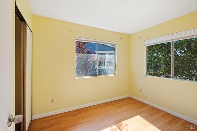 unfurnished bedroom featuring hardwood / wood-style flooring and a textured ceiling