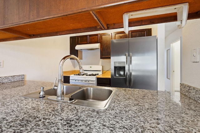 kitchen with sink, white gas stove, and stainless steel fridge with ice dispenser