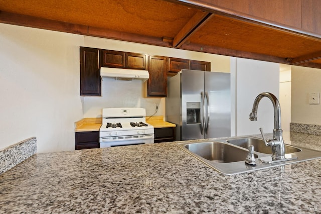 kitchen with stainless steel refrigerator with ice dispenser, sink, and white range with gas cooktop