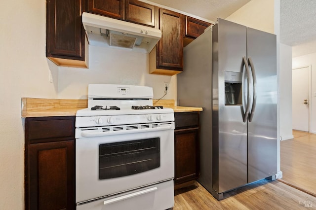 kitchen featuring dark brown cabinets, a textured ceiling, stainless steel fridge with ice dispenser, white gas stove, and light hardwood / wood-style floors