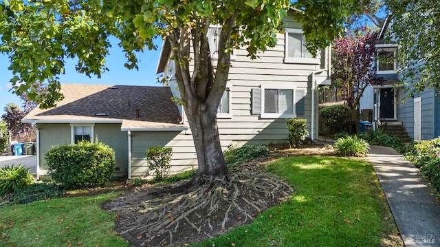 view of side of home with a lawn