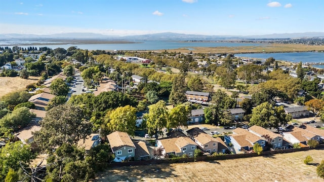 birds eye view of property featuring a water and mountain view