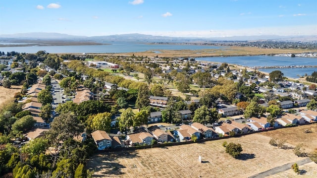 drone / aerial view with a water and mountain view