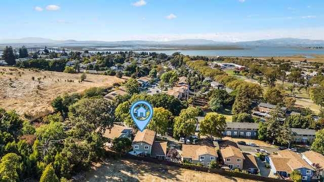 drone / aerial view with a water and mountain view