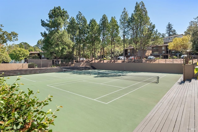 view of tennis court with fence and community basketball court