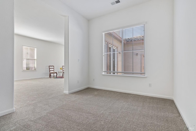 unfurnished room featuring light carpet