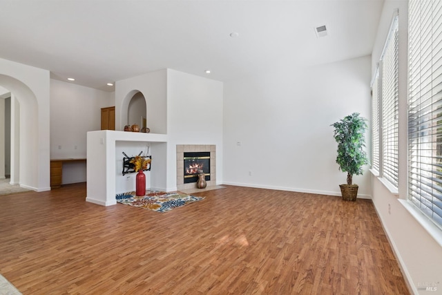 unfurnished living room featuring a fireplace and light hardwood / wood-style flooring