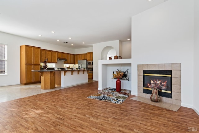 kitchen with light hardwood / wood-style flooring, stainless steel appliances, and a breakfast bar