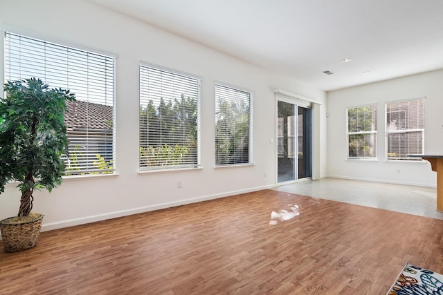 empty room with light hardwood / wood-style flooring