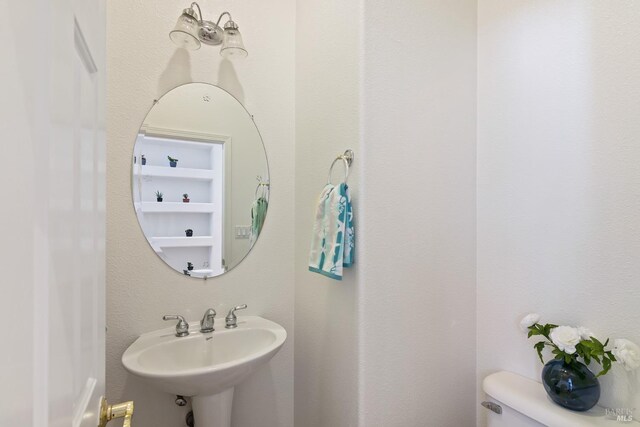 bathroom featuring sink and toilet