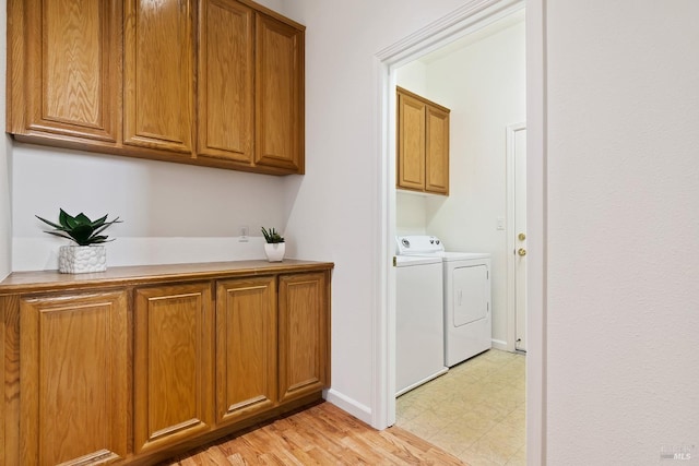 laundry area featuring cabinets and independent washer and dryer