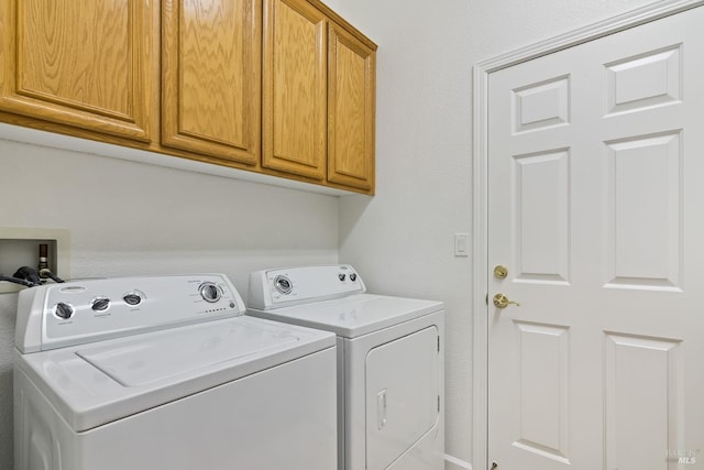 washroom featuring cabinets and washer and dryer