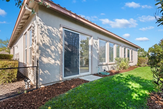 view of home's exterior featuring a yard