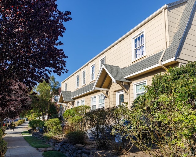 view of side of property with a shingled roof