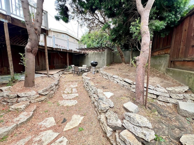 view of yard with a patio area, a fenced backyard, and a wooden deck