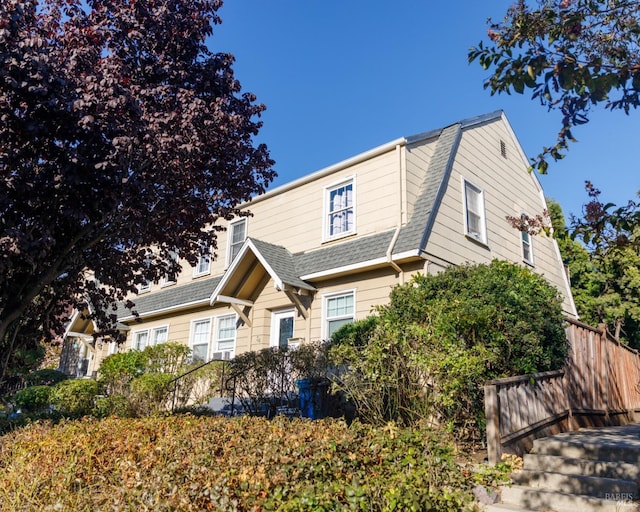 view of front of property featuring roof with shingles and a gambrel roof