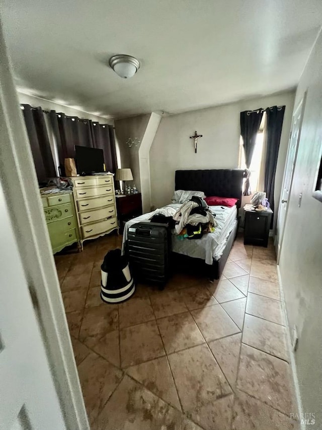 bedroom with light tile patterned floors