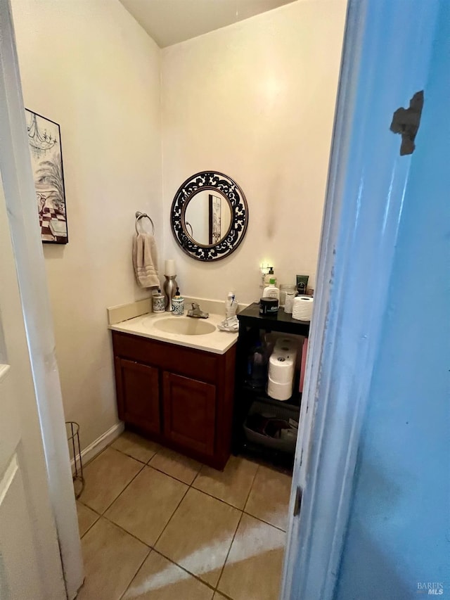 bathroom featuring vanity, baseboards, and tile patterned floors