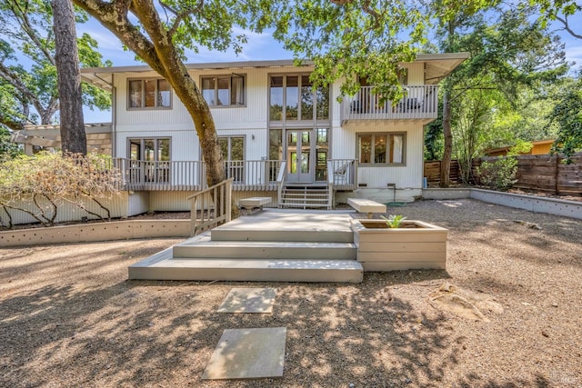 back of house with a balcony and a patio area