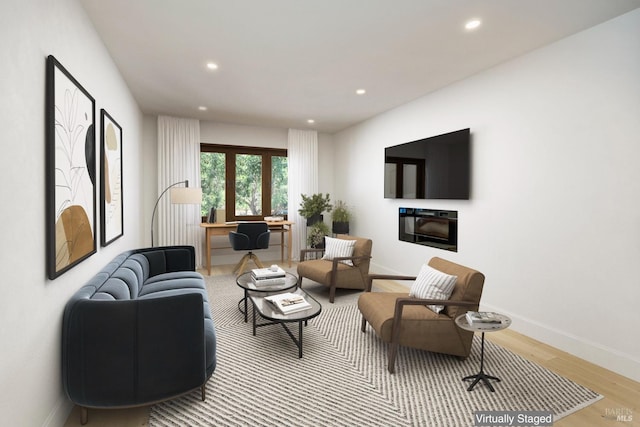 living room with light wood-type flooring and a fireplace