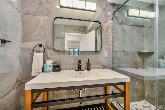 bathroom featuring tile walls, a shower with shower door, and vanity