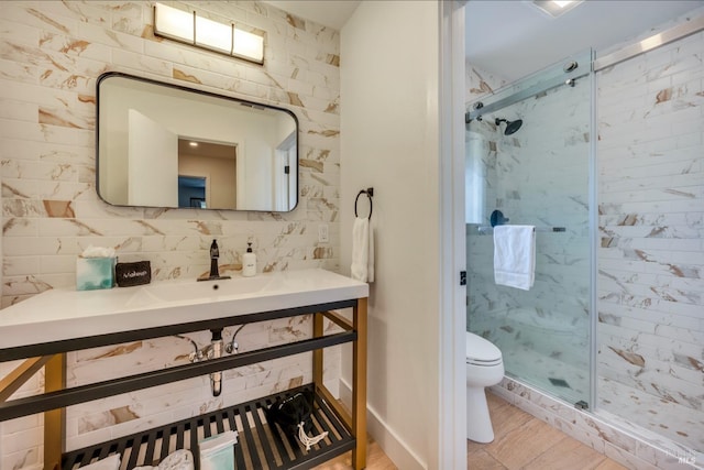 bathroom featuring vanity, a shower with shower door, and toilet