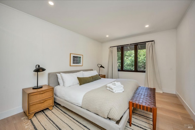 bedroom featuring light hardwood / wood-style floors and ornamental molding