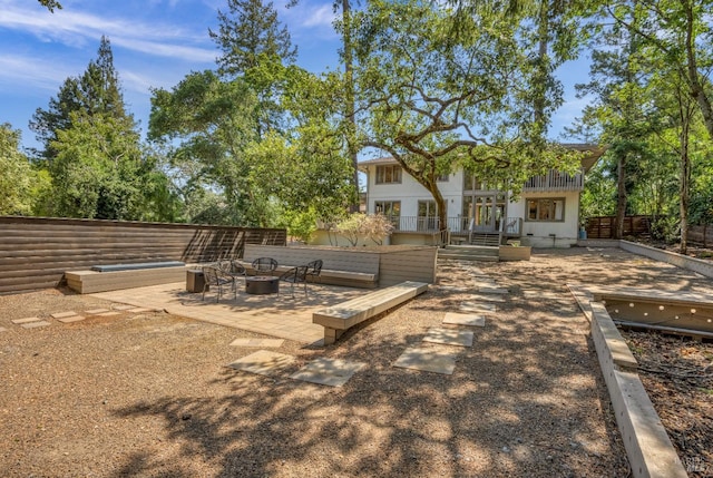 view of yard with a wooden deck, a patio area, and an outdoor fire pit