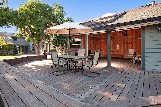 wooden terrace featuring outdoor dining area