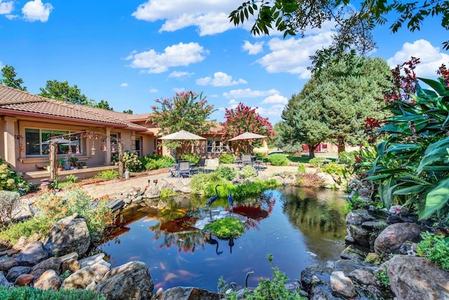 exterior space featuring a garden pond