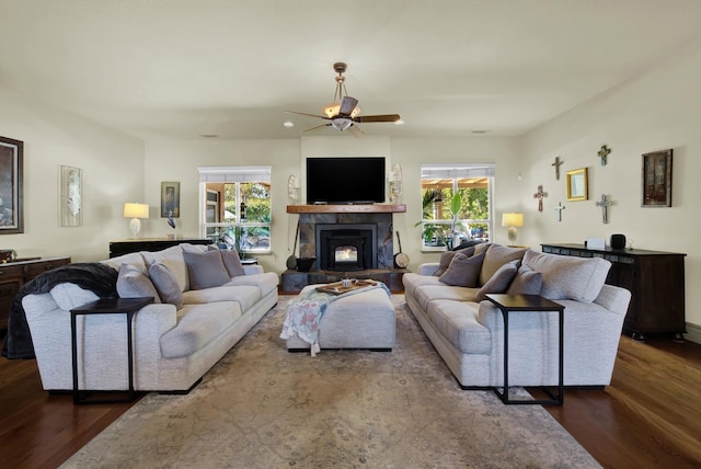 living room featuring ceiling fan and dark hardwood / wood-style flooring