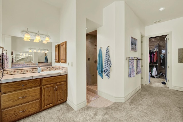 bathroom with vanity, tile patterned floors, and tiled shower