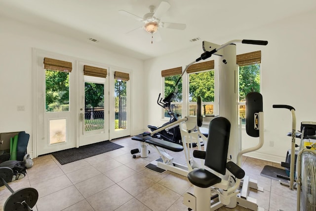 workout room with ceiling fan and light tile patterned floors