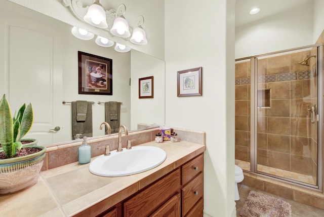 bathroom featuring walk in shower, tile patterned floors, vanity, and toilet