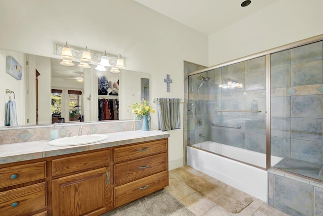 bathroom with enclosed tub / shower combo, tile patterned floors, ceiling fan, and vanity