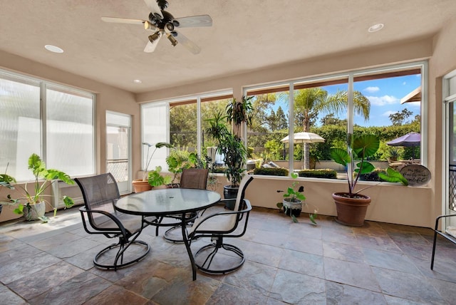 sunroom / solarium featuring ceiling fan