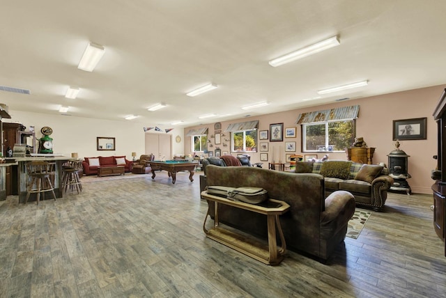 living room with bar, wood-type flooring, and billiards