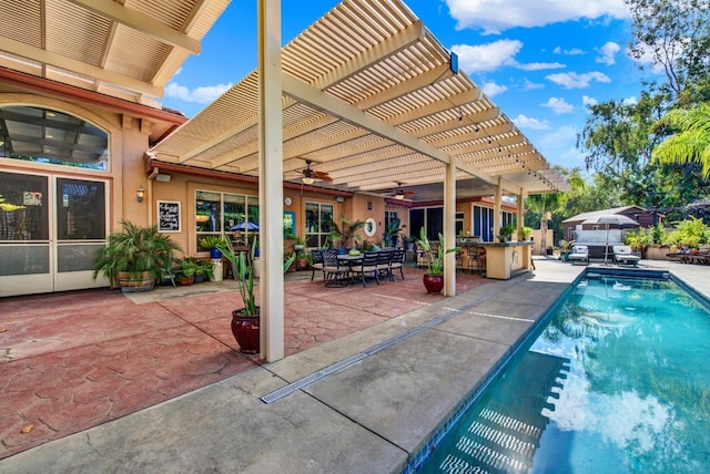 view of pool with a bar, a pergola, a patio, and ceiling fan