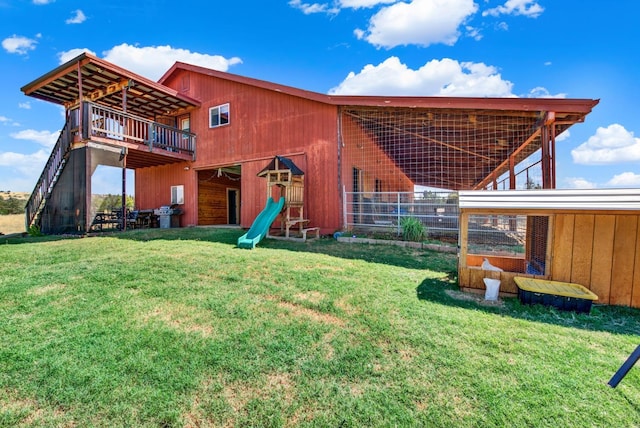 back of house with an outdoor structure and a lawn