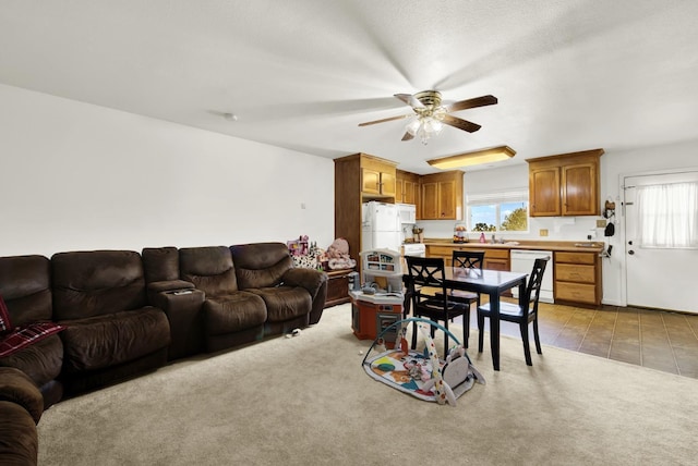 living room featuring sink, a wealth of natural light, and light colored carpet