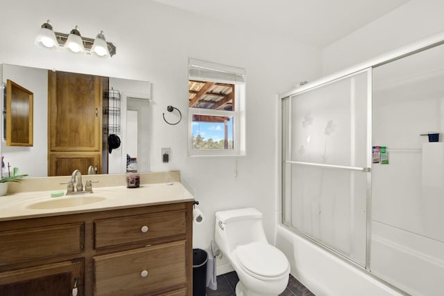 full bathroom with enclosed tub / shower combo, vanity, and toilet