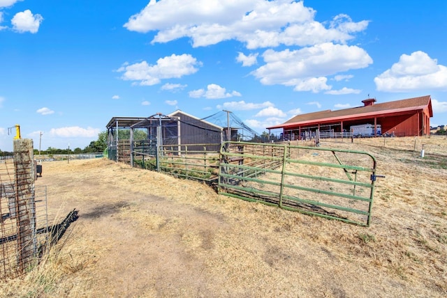 view of horse barn with a rural view