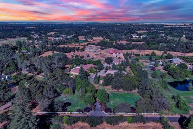 aerial view at dusk with a water view