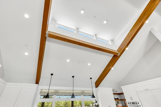 interior details featuring pendant lighting, white cabinets, and beamed ceiling