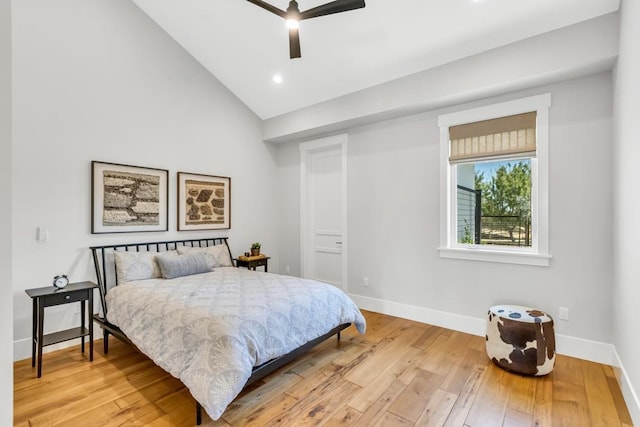 bedroom with light hardwood / wood-style flooring, ceiling fan, and vaulted ceiling