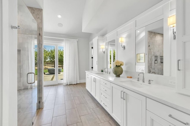 bathroom with a shower with door and vanity